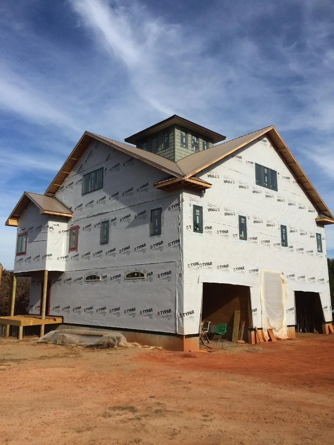 New two story house under construction with a cupola and gabled roofs in Pine Mountain Valley